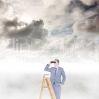 Composite image of businessman looking on a ladder