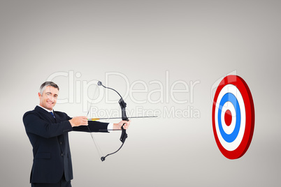 Composite image of smiling businessman stretching a bow