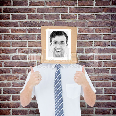 Composite image of businessman with photo box on head