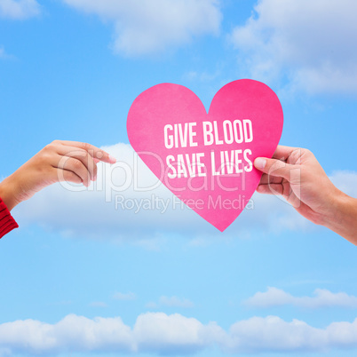 Composite image of couple holding a heart