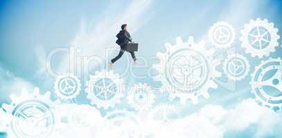 Composite image of businessman jumping