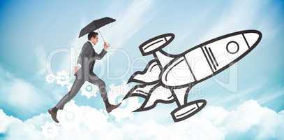 Composite image of businessman jumping holding an umbrella