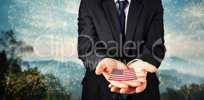 Composite image of mature businessman holding his hands out