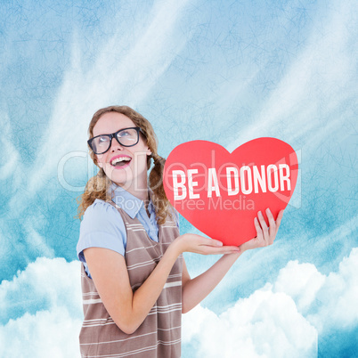 Composite image of geeky hipster woman holding heart card