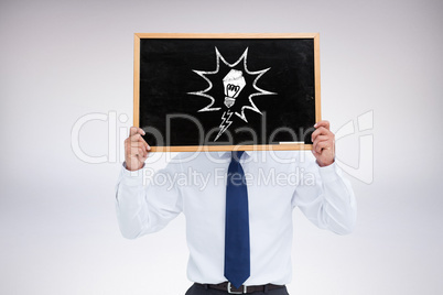 Composite image of businessman showing board