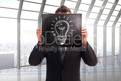 Composite image of businessman showing board