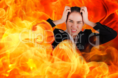 Composite image of stressed businesswoman with hands on her head