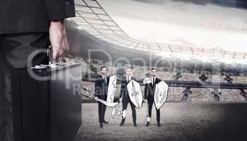 Composite image of businessman holding briefcase