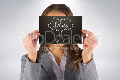 Composite image of businesswoman showing card