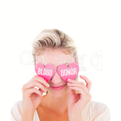 Composite image of attractive young blonde holding hearts over e