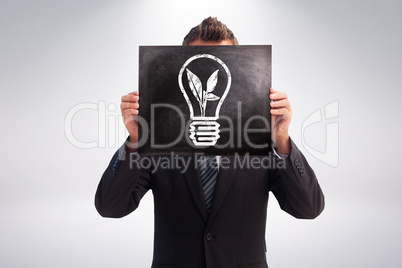 Composite image of businessman showing board