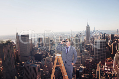 Composite image of businessman looking on a ladder