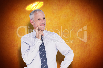 Composite image of businessman thinking