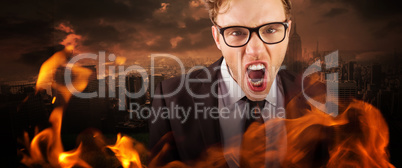 Composite image of young angry businessman shouting at camera