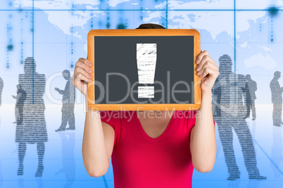 Composite image of woman covering face with chalkboard