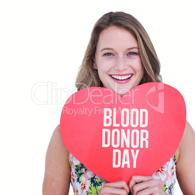 Composite image of woman holding heart card