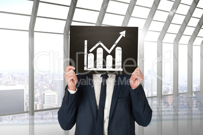 Composite image of businessman holding board