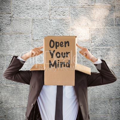 Composite image of anonymous businessman pointing to box