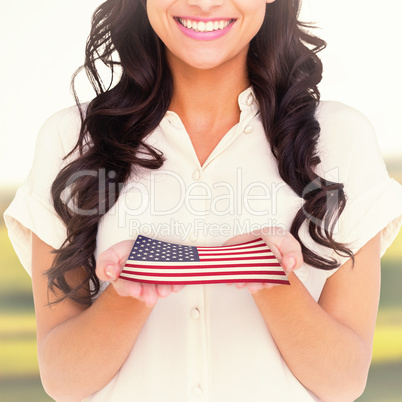 Composite image of pretty brunette holding out hands