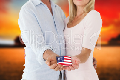 Composite image of happy couple holding their hands out