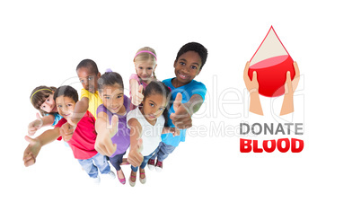 Composite image of elementary pupils smiling showing thumbs up
