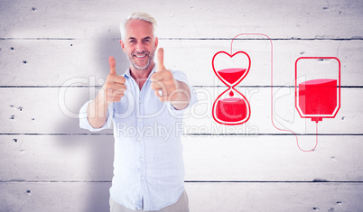 Composite image of smiling man showing thumbs up to camera