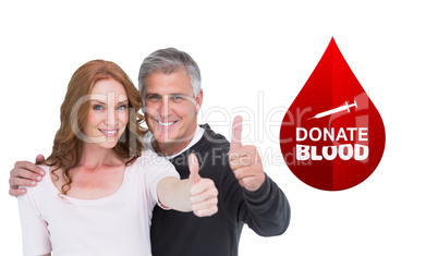 Composite image of casual couple showing thumbs up