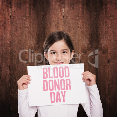 Composite image of cute little girl showing card