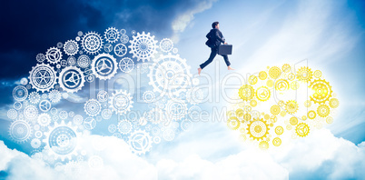 Composite image of businessman jumping