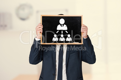 Composite image of businessman holding board