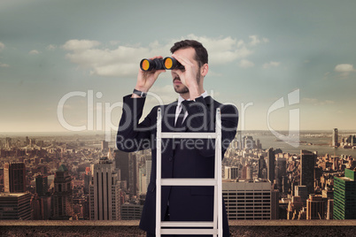 Composite image of businessman looking on a ladder