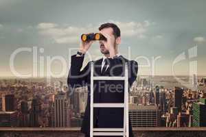 Composite image of businessman looking on a ladder