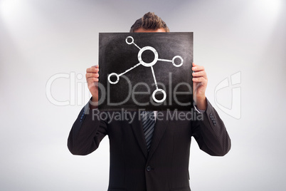 Composite image of businessman showing board