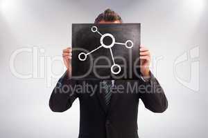 Composite image of businessman showing board