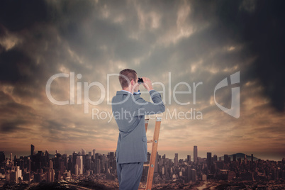 Composite image of businessman looking on a ladder