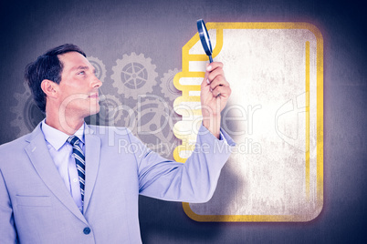 Composite image of concentrated businessman using magnifying gla