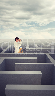 Composite image of businessman looking on a ladder