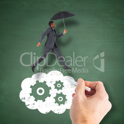 Composite image of businessman walking and holding umbrella