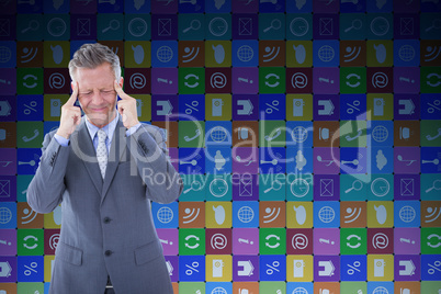 Composite image of businessman with headache