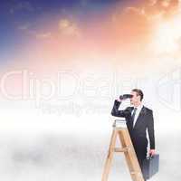 Composite image of businessman looking on a ladder