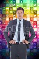 Composite image of serious businessman with hands on hips