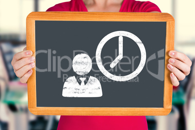 Composite image of woman showing chalkboard to camera