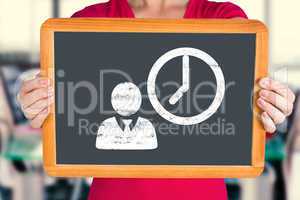 Composite image of woman showing chalkboard to camera
