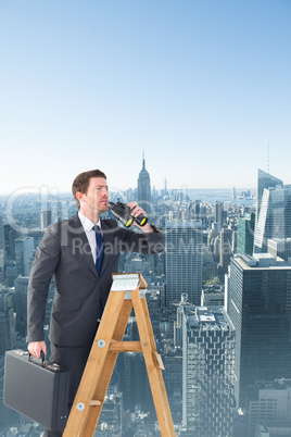 Composite image of businessman looking on a ladder