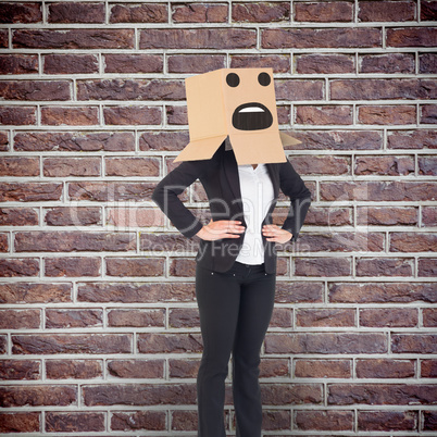 Composite image of businesswoman with box over head