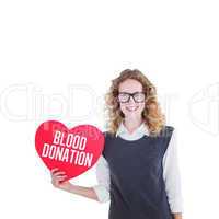 Composite image of geeky hipster holding heart card