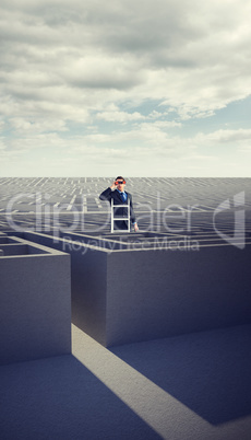 Composite image of businessman looking on a ladder