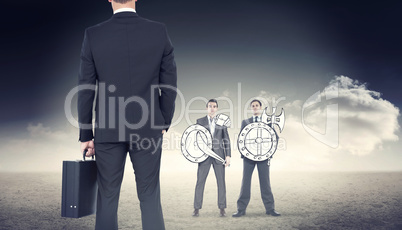 Composite image of businessman standing with his briefcase