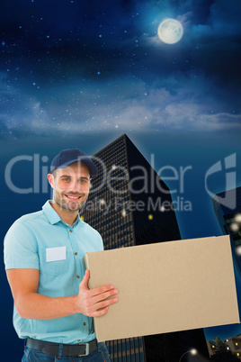 Composite image of courier man carrying cardboard box