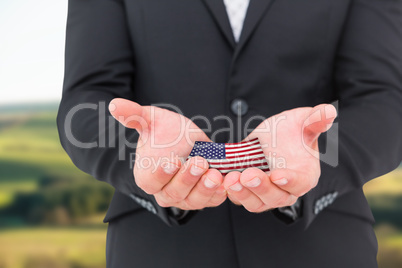 Composite image of businessman holding his hands out